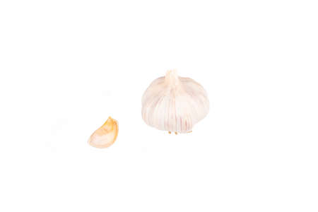 Studio lighting. A head of garlic and a small slice on a white background. Close-upの写真素材