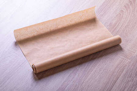 parchment. baking paper on a wooden background in retro style. close-up