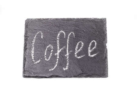 coffee. an inscription on a black stone in white chalk. taken on a white background.の写真素材