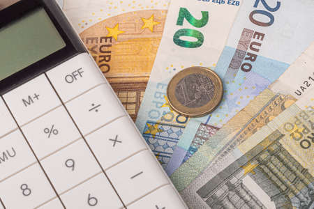 money, euro, white calculator. the concept of buying and maintaining a house, apartment, credit relations, loan,の写真素材