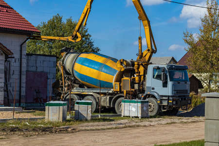 street lighting. the truck is pouring concrete. a private house is being built.の写真素材