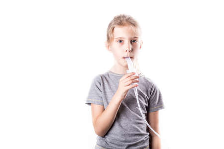 on a white background. a girl with white hair. she's wearing a medical transparent mask. the inhalerの写真素材