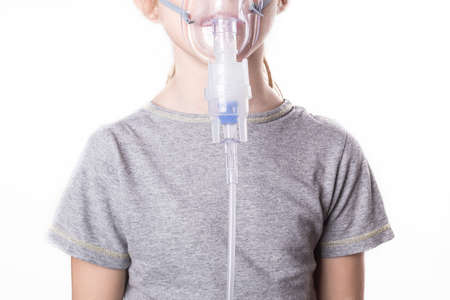 on a white background. a girl with white hair. she's wearing a medical transparent mask. the inhaler. close-upの写真素材