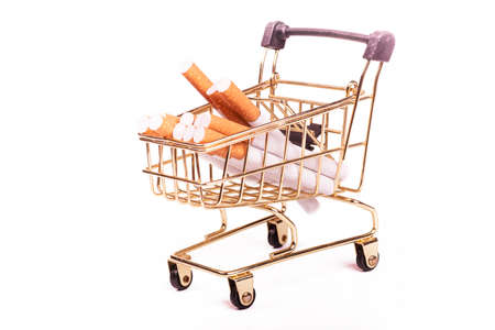 a few cigarettes. they are packed in a toy cart. on a white background. close-up.の写真素材