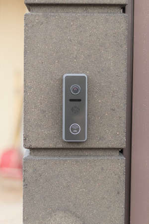 street lighting. the table is made of concrete. It has a bell installed on it. Provides video...