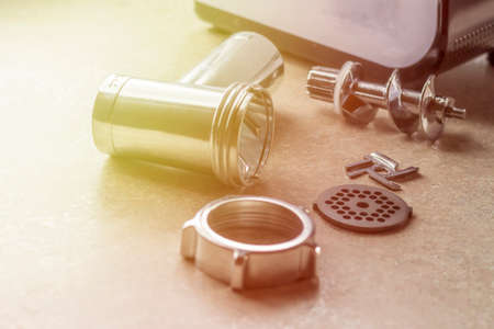 soft focus. natural light. electric meat grinder its components lie side by side. close upの写真素材