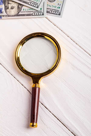 white wooden background in retro style. magnifying glass. close upの写真素材