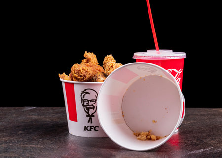Minsk, Belarus - May 2019. Tray with paper cup of cold Coca Cola drink, fried potato and chicken burger at checkout. Sandwich with KFC and cup with Coca-Cola on cashier, payment of orderのeditorial素材