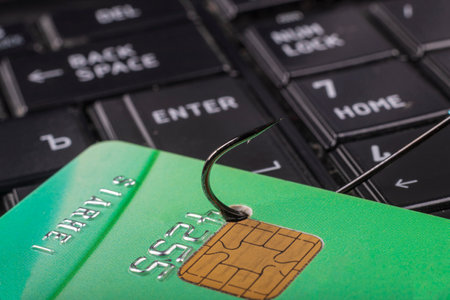 soft focus. close up. bankcard. the keyboard is black. a fishing hook. concept. stealing money on the Internetの写真素材