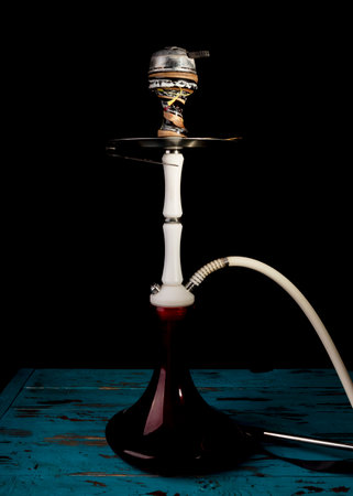 close up. Hookah with a glass flask and a metal bowl hookah without smoke. Black background. front view.の写真素材