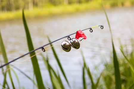 spinning. the bell is twitching. there is a bite. late evening. focus on the bellsの写真素材