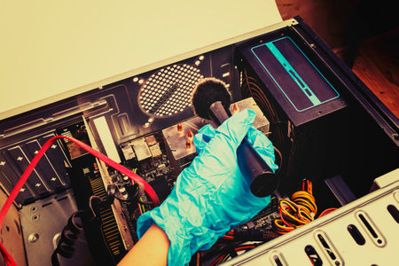 the home computer is covered in dust. cable in the mud. concept cleaning and cleaning of computer equipment.の写真素材