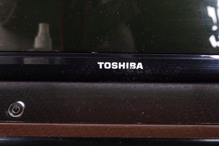 Minsk, Belarus, January 9, 2024. A Toshiba laptop. An old laptop has scratches with long use, dustのeditorial素材