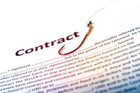 a contract, an inscription on a white piece of paper. there is a fishing hook nearby. the concept of deception when making a deal. close-upの写真素材