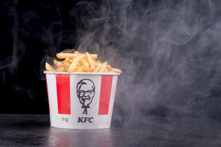 Minsk, Belarus, July 05, 2024: black background smoke steam night French fries