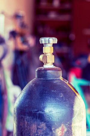 valve on the oxygen cylinder. Cylinder compressed gases for oxygen, nitrogen, carbon dioxide, hydrogen and argon for weldingの写真素材