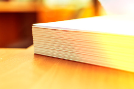 Stacks of white papers work large stacks of papers stacked together. On a desk in an office. Documents that are yet to be printed or made. Business concept.の写真素材
