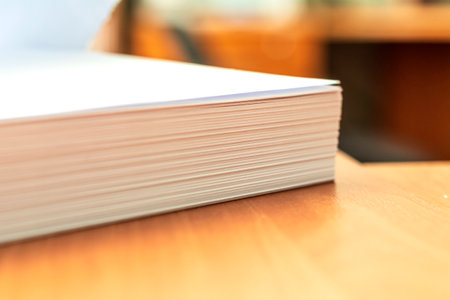 Stacks of white papers work large stacks of papers stacked together. On a desk in an office. Documents that are yet to be made. Business concept.の写真素材