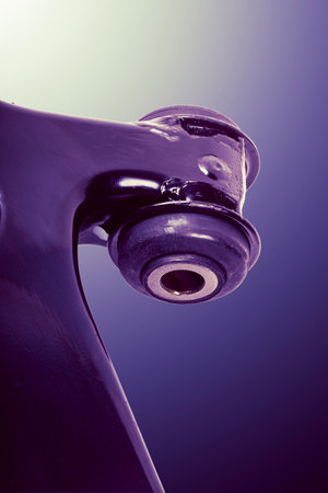 A detailed view of a control arm used in automotive suspension systems, showing its metallic structure, bushings, and connection points for functionality and repair assessments.の写真素材