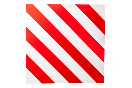 A large road sign displays a pattern of red and white stripes, warning drivers about oversized cargo restrictions. This alert is essential for safe navigation on rural highways.の写真素材