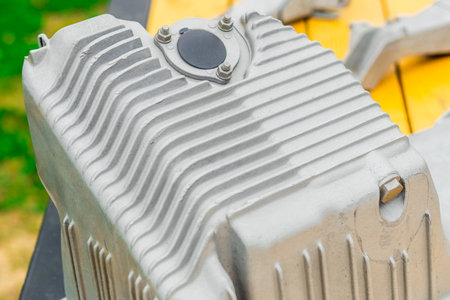 The metal engine component showcases intricate design features, capturing the smooth surfaces and...