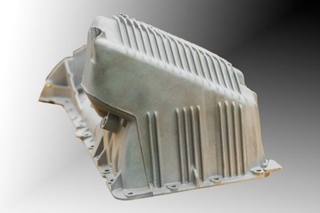 The metal engine component showcases intricate design features, capturing the smooth surfaces and...