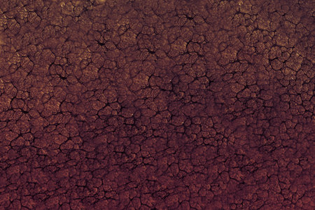 A striking textured surface showcases a deep reddish color with a pattern reminiscent of cracked earth, evoking the beauty of natural landscapes and geological formations.の写真素材