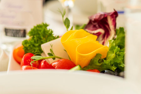 A colorful salad with fresh greens, juicy tomatoes, and flavorful cheese, perfect for a nutritious mealの写真素材