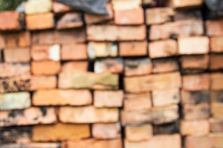 Stacked clay bricks showcasing a rustic texture and earthy colors at a construction site in a sunny...