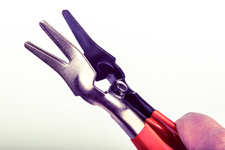 A cutting tool designed with handles and working edges to help users easily cut through different materials. This tool is useful in workshops and home projects for creating precise shapes.の写真素材