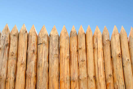 Wooden paling from the sharp raw logsの写真素材
