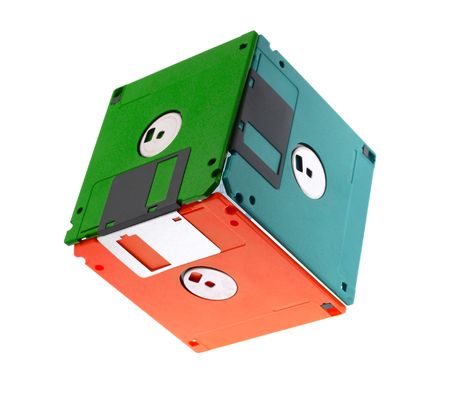 Multi-coloured cube made of old diskettes, on a white backgroundの写真素材