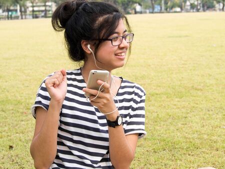 Woman relaxing and listening to music outdoors 