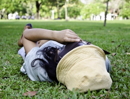 Exhausted student over the grass in the park の写真素材