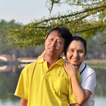 Happy mother and father in the park outdoorの写真素材