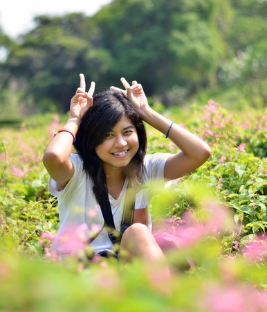 Portrait of sweet young woman sitting outdoors and smiling の写真素材