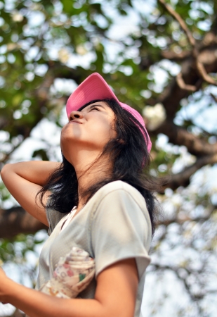 Enjoying the nature. Young woman arms raised enjoying the fresh air in green forest. の写真素材