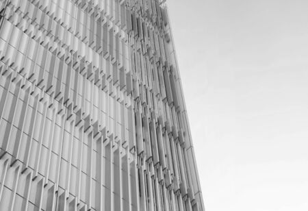 Modern office building with blue fins pattern, black and white toneの写真素材