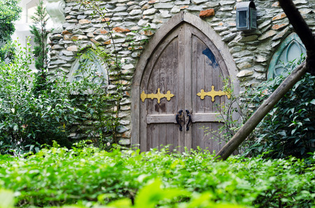 Old wooden door in castle with stone wallの写真素材