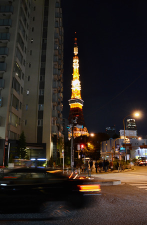 Tokyo, Japan - November 28, 2013: View of busy street at night with Tokyo Tower in the distance in Tokyo, Japan on November 28, 2013.のeditorial素材