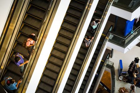 Bangkok, Thailand - September 12, 2013: Shoppers on escalator at Terminal21 shopping mall on September 12, 2013. Terminal21 is a new shopping mall in the Asok district in Bangkok, Thailandのeditorial素材