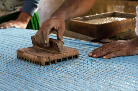 Wooden stamp tool on indian colorful fabricの写真素材
