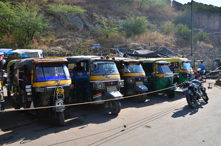 Jaipur, India - December 29, 2014:  Auto rickshaw taxis near Amber fort on December 29, 2014 in Jaipur, India. These iconic taxis have recently been fitted with CNG powered engines in an effort to reduce pollutionのeditorial素材