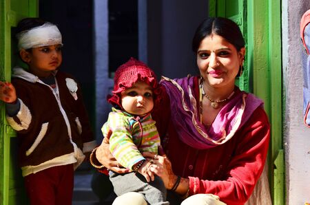 Jodhpur, India - January 1, 2015: Indian proud mother poses with her children in Jodhpur, India. Jodhpur is the second largest city in the Indian state of Rajasthan with over 1 million habitants.のeditorial素材