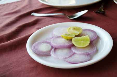 Lemon and onions on table in restaurant.の写真素材