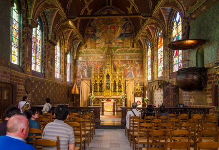 Bruges, Belgium - May 11, 2015: Tourist visit Interior of Basilica of the Holy Blood in Bruges, Belgium on May 11, 2015. Basilica is located in the Burg square and consists of a lower and upper chapel.のeditorial素材