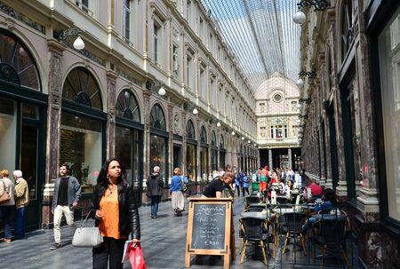 Brussels, Belgium - May 12, 2015: Tourists shopping at The Galeries Royales Saint-Hubert in Brussels, Belgium. This place is a glazed shopping arcade in Brussels that preceded other famous 19th-century shopping arcades.のeditorial素材