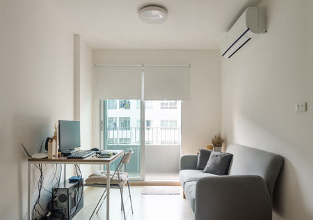 Living room with working table in modern apartmentの写真素材