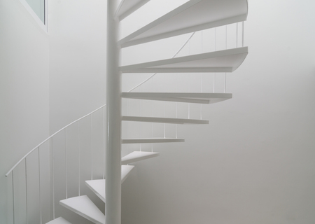 Modern space with white spiral stairの写真素材
