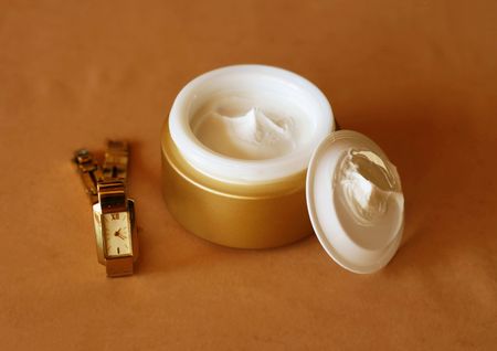 Face cream with a golden watchの写真素材